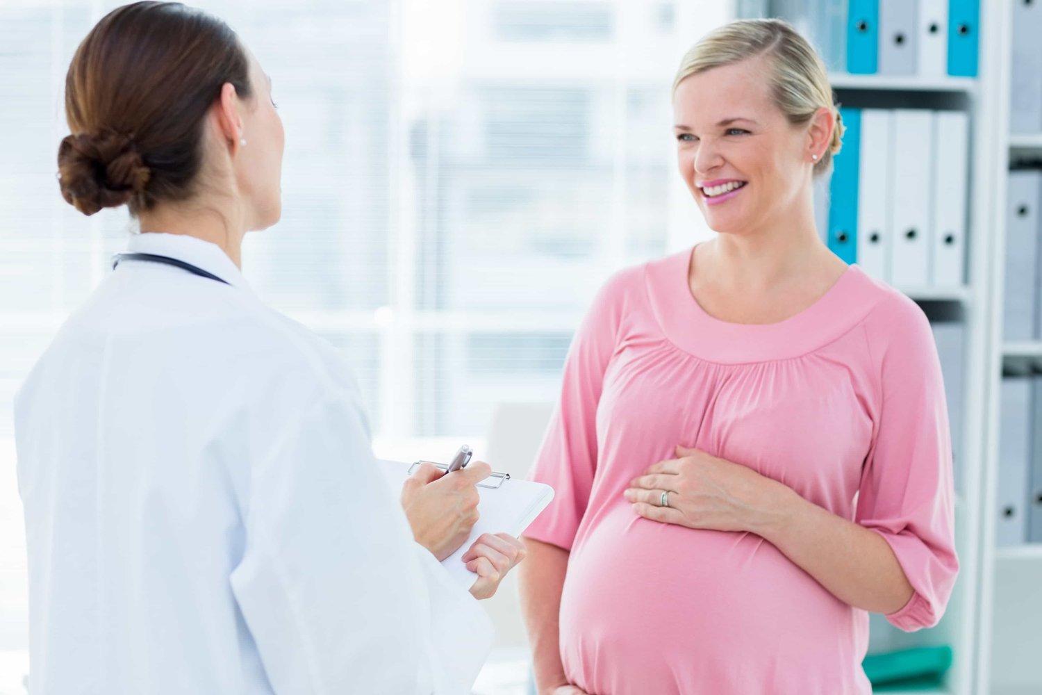 smiling surrogate mother talking to doctor