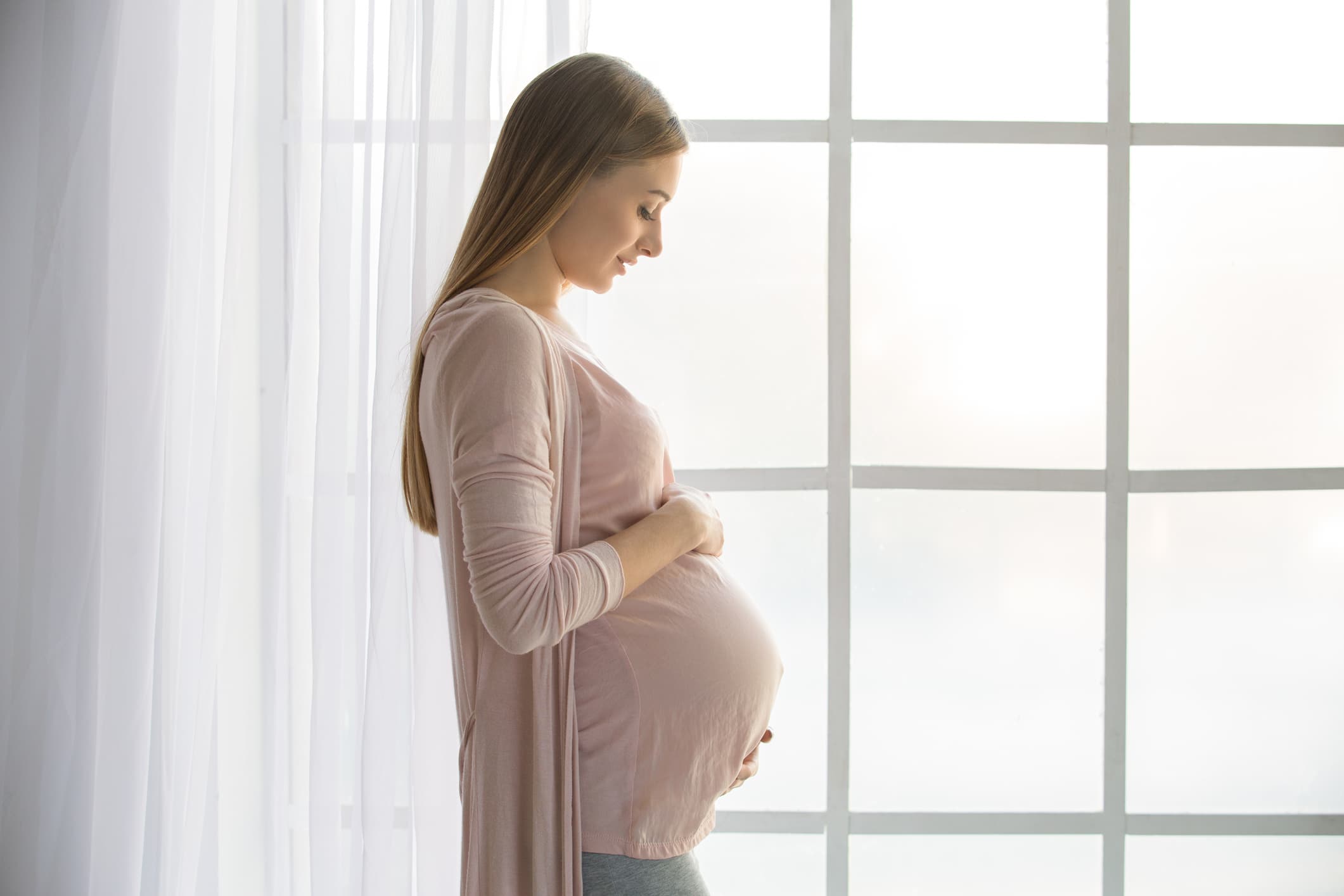 pregnant surrogate holding stomach